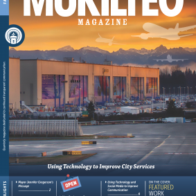 cover of Fall 2015 Mukitleo Magazine, image of Boeing Plan at dusk